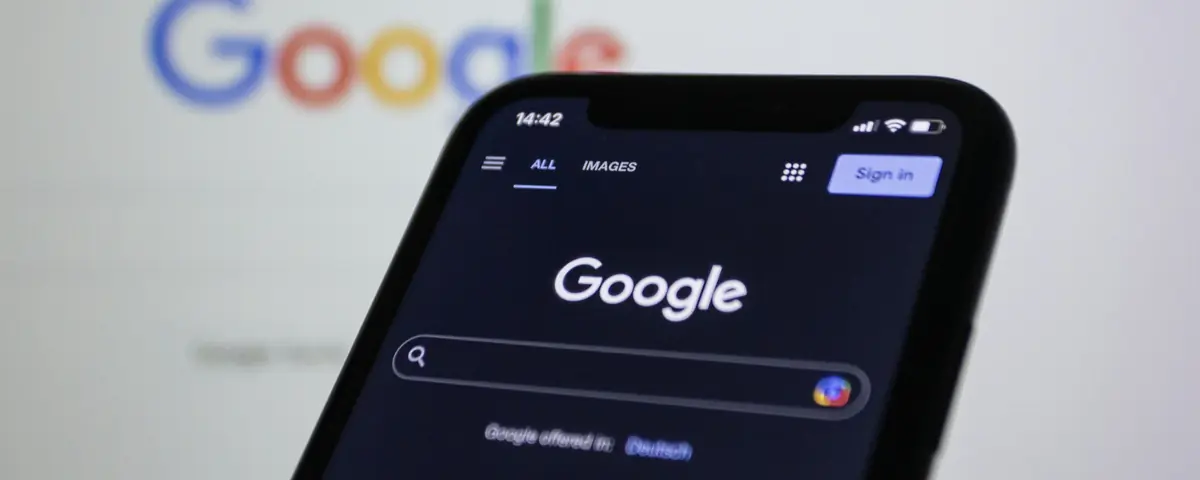 Google's home page on a smartphone, the Google logo blurred in the background