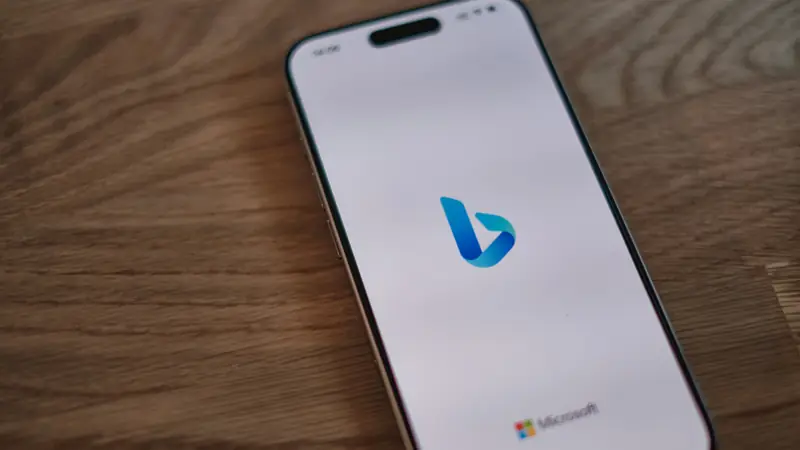 The Bing logo on a smartphone lying on a wooden table